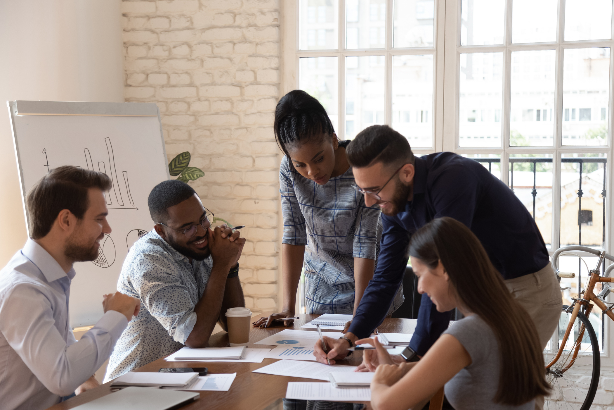 Arab team leader and group analyzing official papers sales results